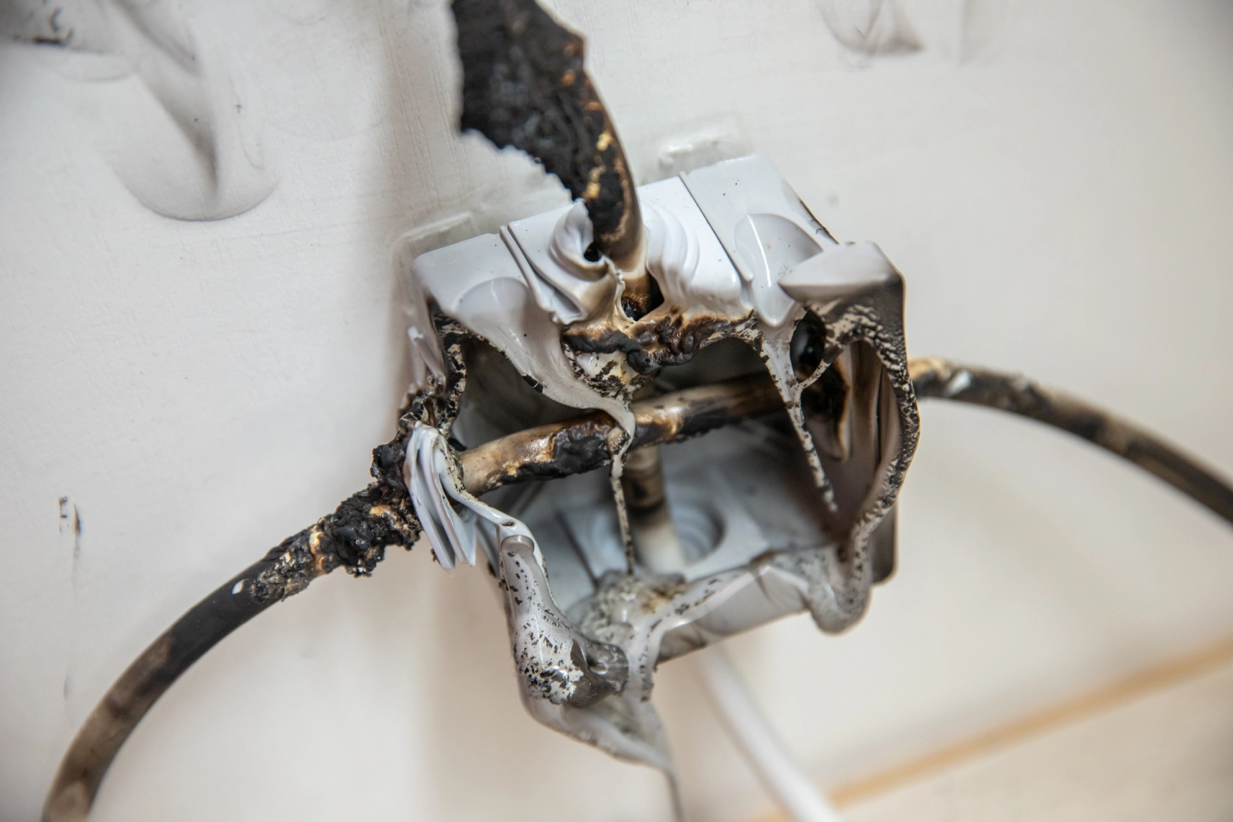 Damaged wiring behind a household electrical socket