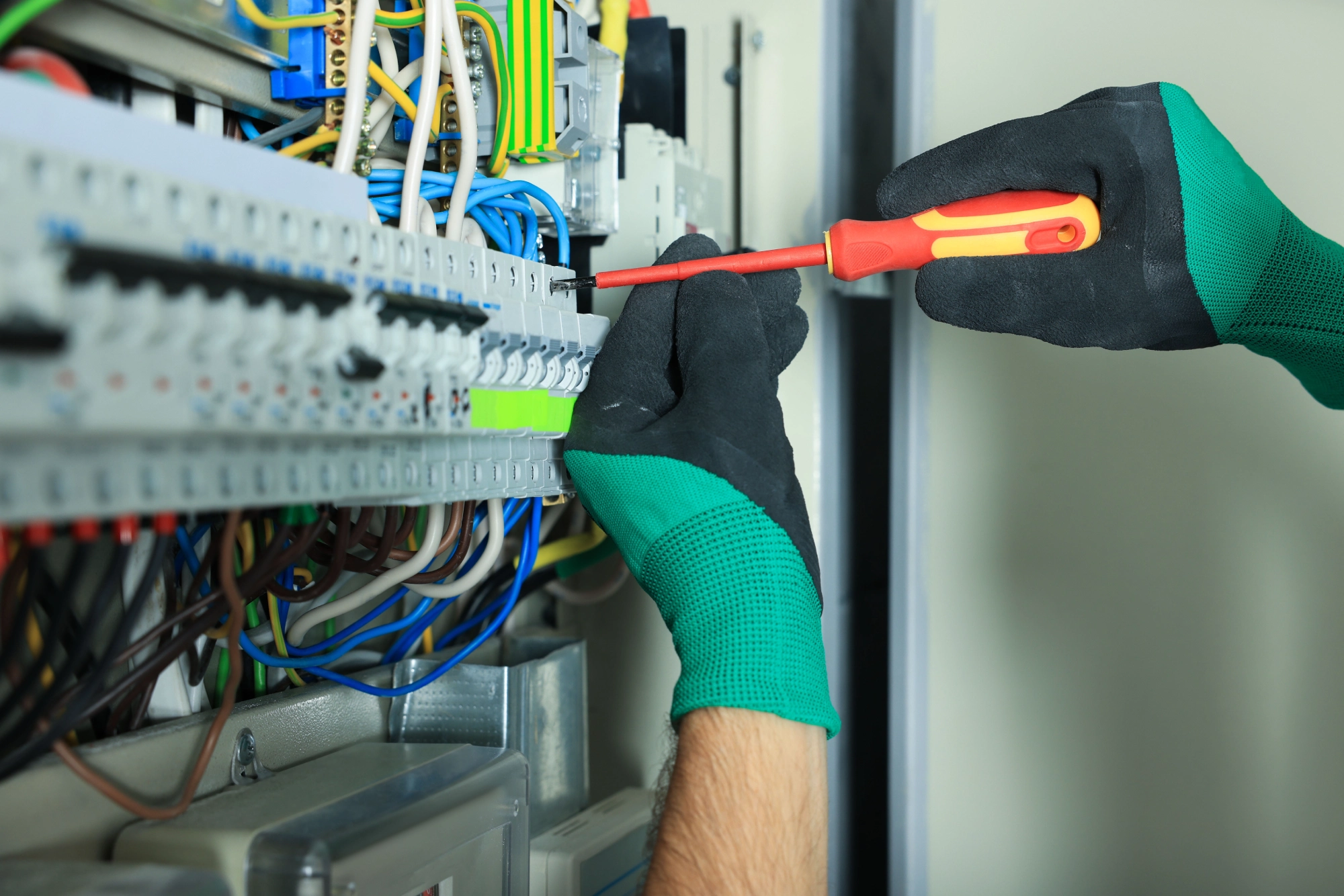 Electrician inspecting faulty circuit breakers
